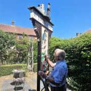 David Brackenbury painting the Wymondham town sign