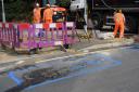 Anglian Water workmen fill in the sinkhole at the Connaught Road and Station Road junction in Attleborough