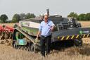 William Mumford, managing director of ASC Autonomy, with the AgXeed AgBot robotic tractor at the Normac cultivations event near Wymondham