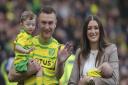 Norwich City defender Ben Gibson with his family on the pitch at Carrow Road at the end of the season