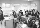 Hands raised to answer one of the teachers at Wymondham College. Date: May 10, 1965.