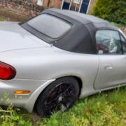 A man who abandoned his car on a grass verge in Attleborough has been fined