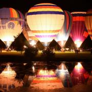 Hot air balloons are lit up as they take part in the night glow in the Old Buckenham Country Park Balloon Festival. Picture: DENISE BRADLEY