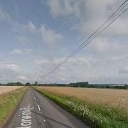 A road between Hardingham and Kimberly, near Wymondham, has been closed due to an electric cable catching fire