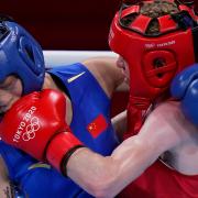 Britain's Charley-Sian Davison, right, exchanges punches with China's Chang Yuan during their women's flyweight 51-kg boxing match at the 2020 Summer Olympics, Thursday, July 29, 2021, in Tokyo, Japan.