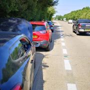 Cars were forced to pull over after hitting the damaged road surface on the A11 back in July